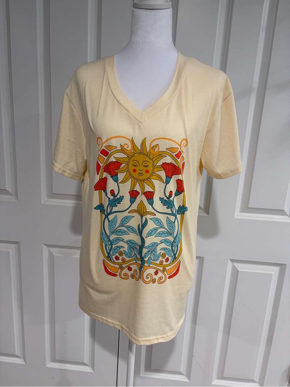 Amazon Cream V-Neck Tee with Sun & Floral Graphic